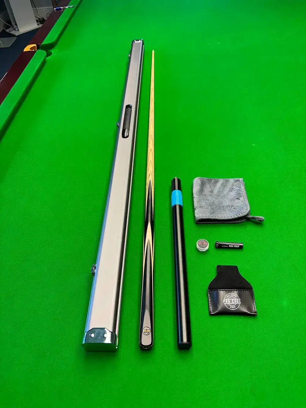 pro edge snooker cue and accessories on a snooker table