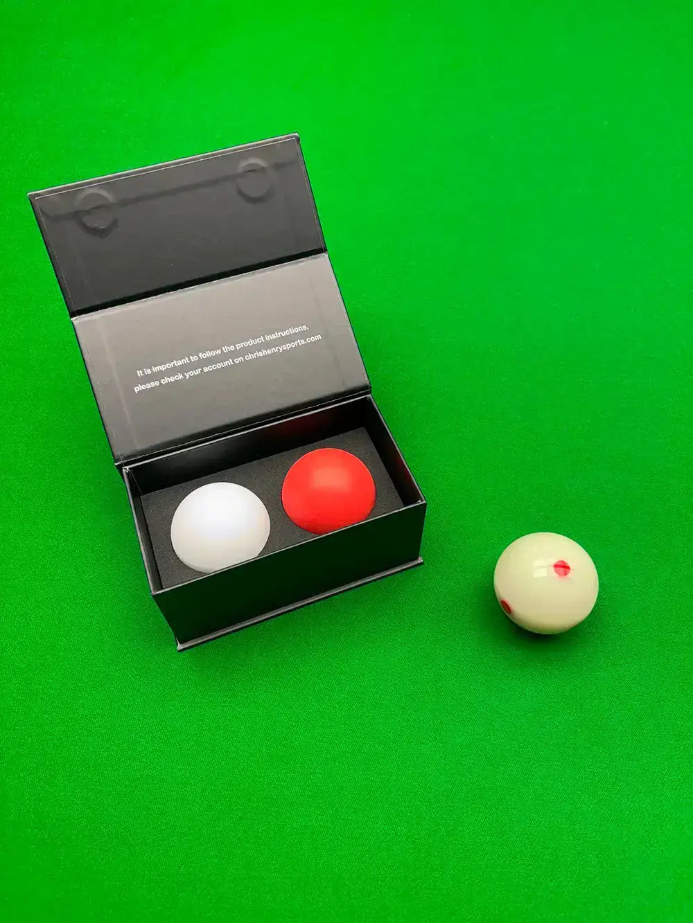the balls by chris henry and a spotted cue ball on a snooker table