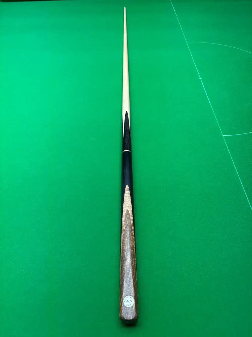 maple snooker cue on a snooker table