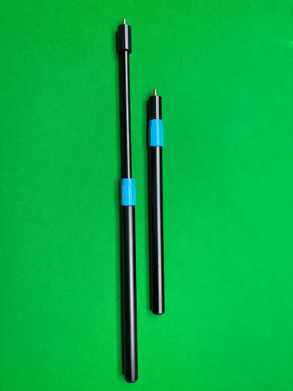 two cue extensions on a snooker table