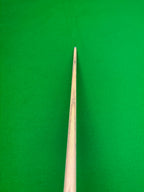 A close-up of a wooden snooker cue shaft standing vertically against a bright green felt background.