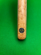 ash snooker cue with a pro edge cues logo on a snooker table