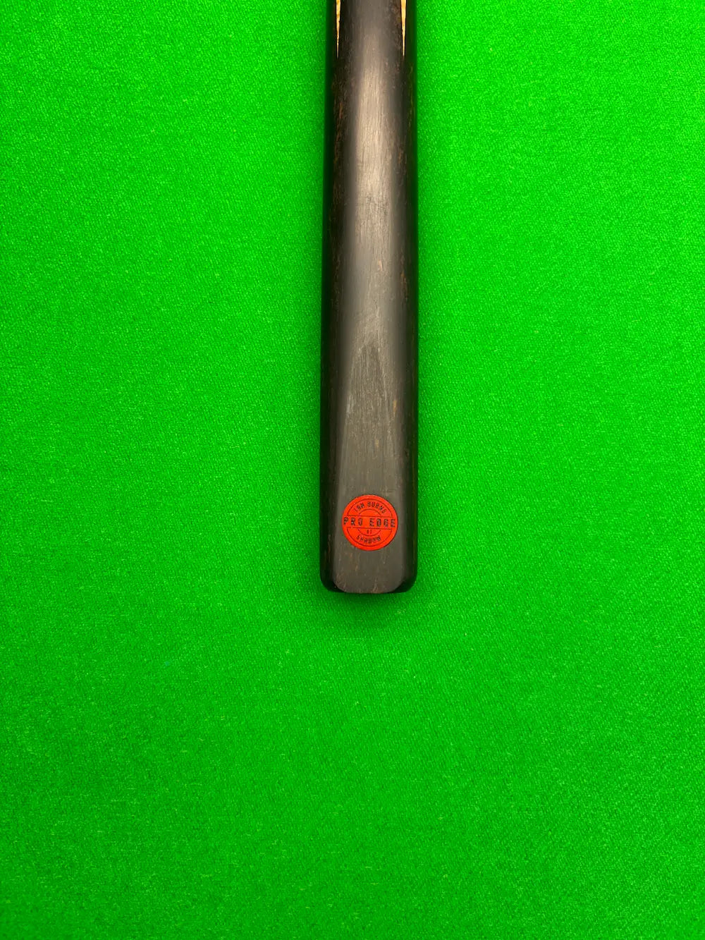 Snooker cue on a snooker table ebony butt