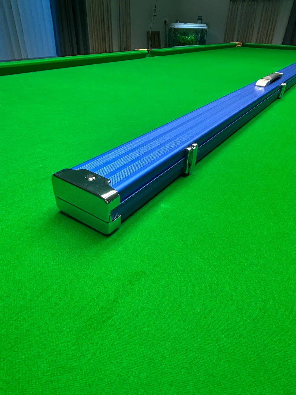 Blue snooker cue case on a snooker table