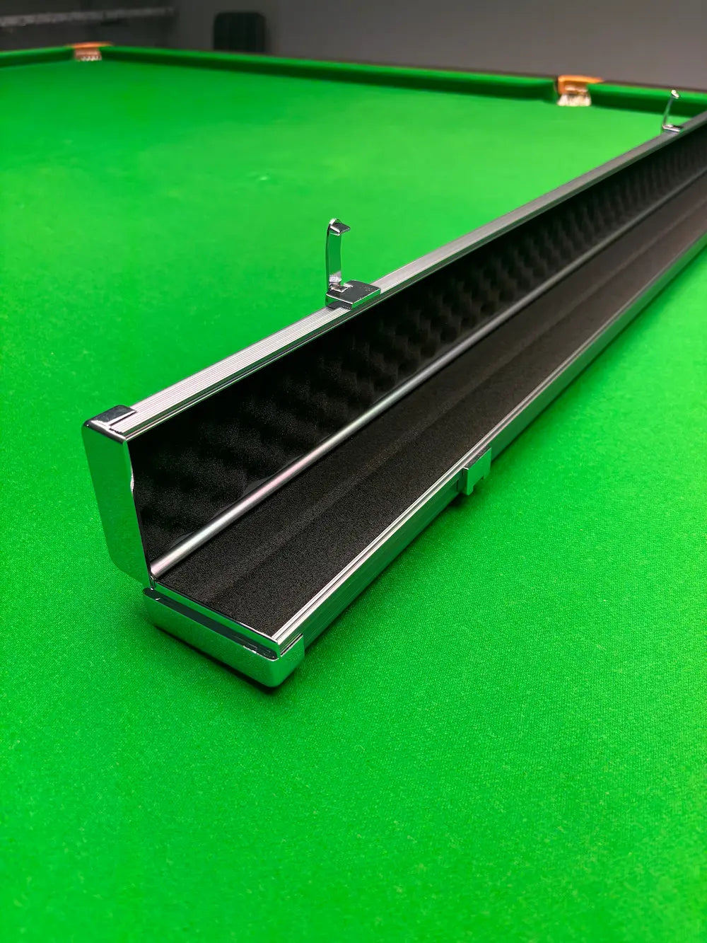 aluminum snooker cue case on a snooker table