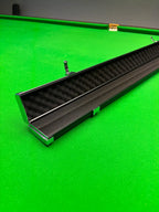 black snooker cue case on a snooker table