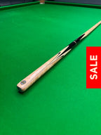Snooker cue on sale on a green snooker table