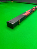 Snooker cue case with checkered wrap on a green snooker table