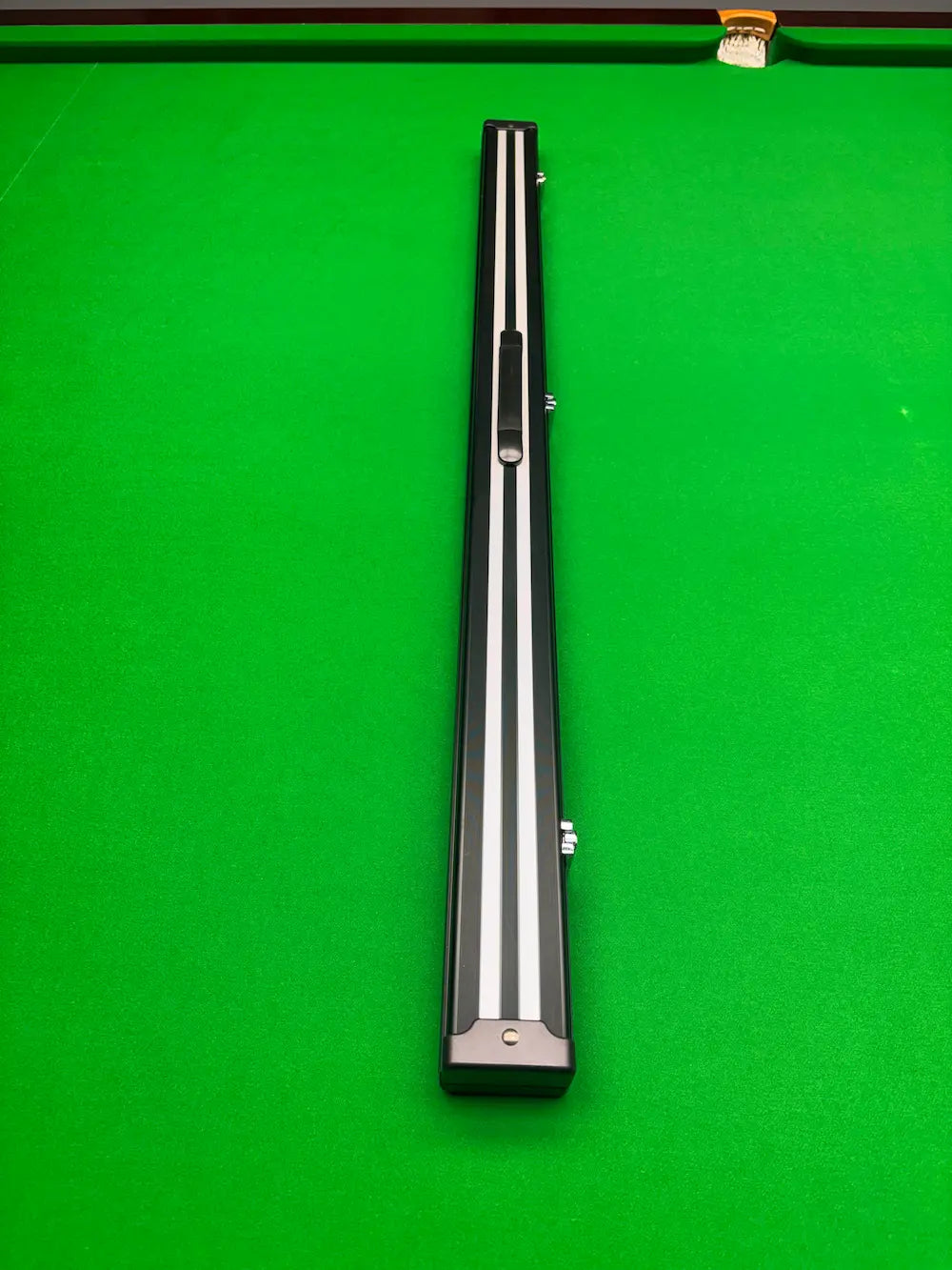 black and white strip case on a snooker table