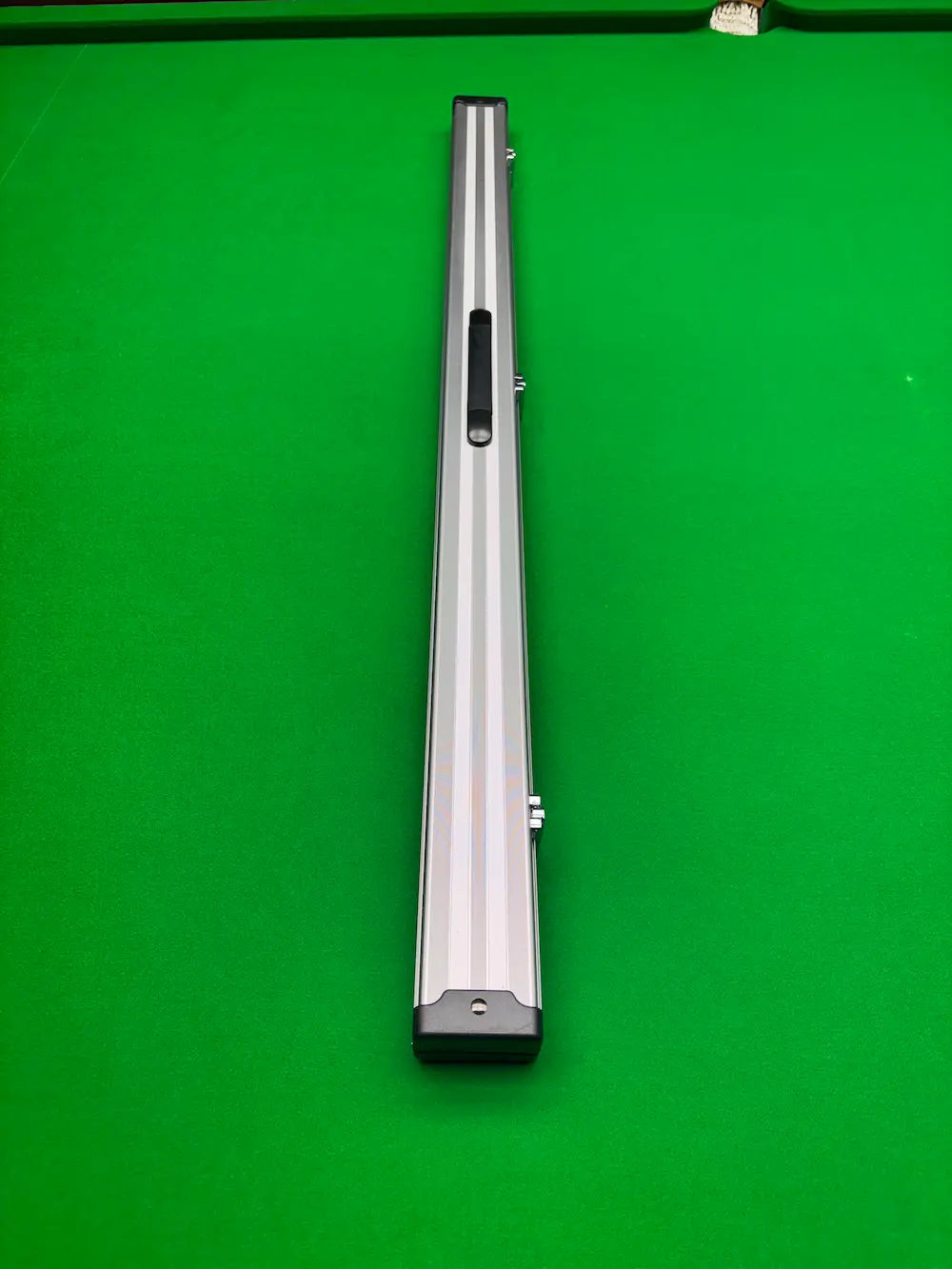 aluminium cue case on a snooker table