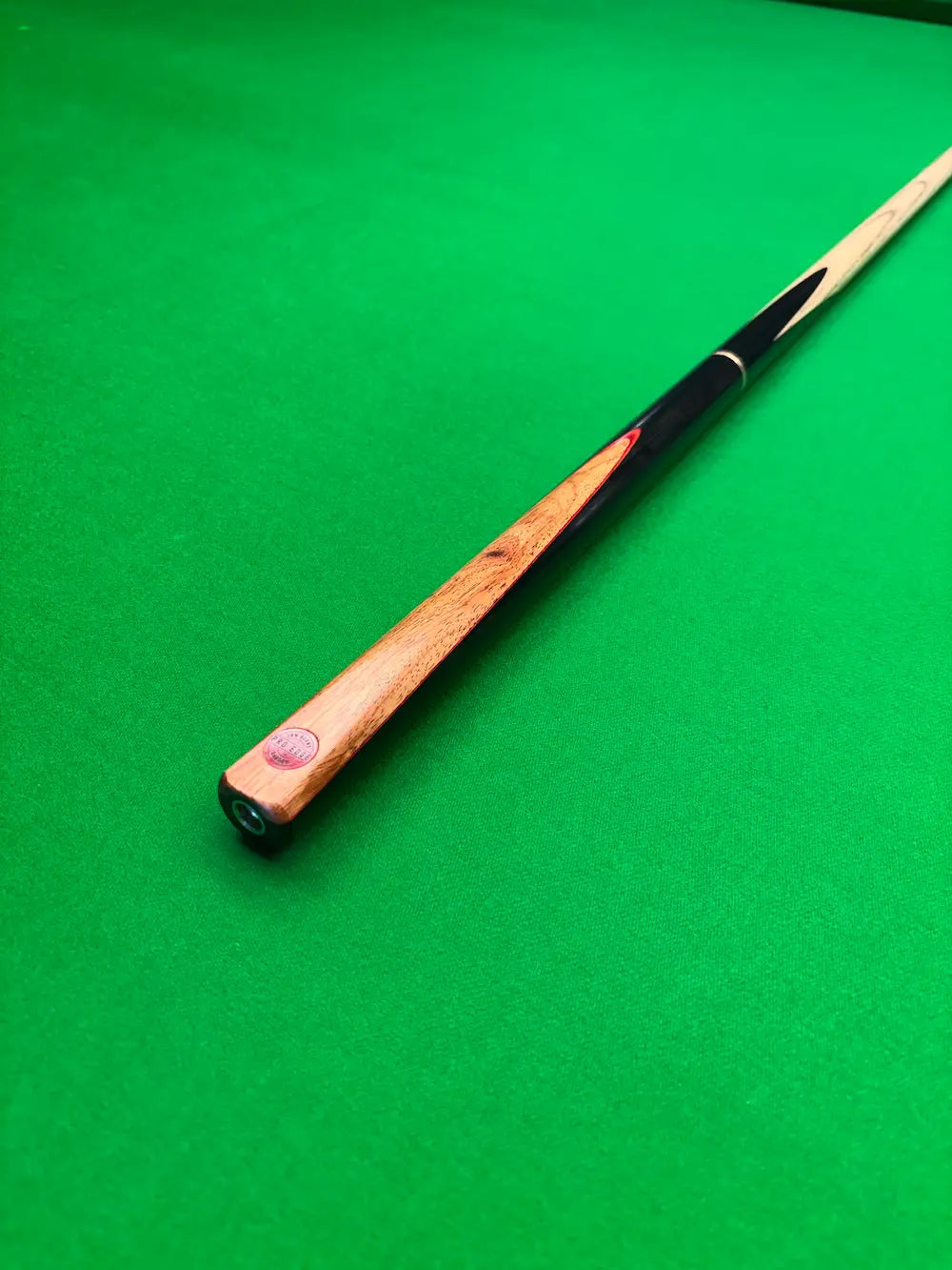 Ebony and Orange Padauk snooker cue on a snooker table by pro edge snooker
