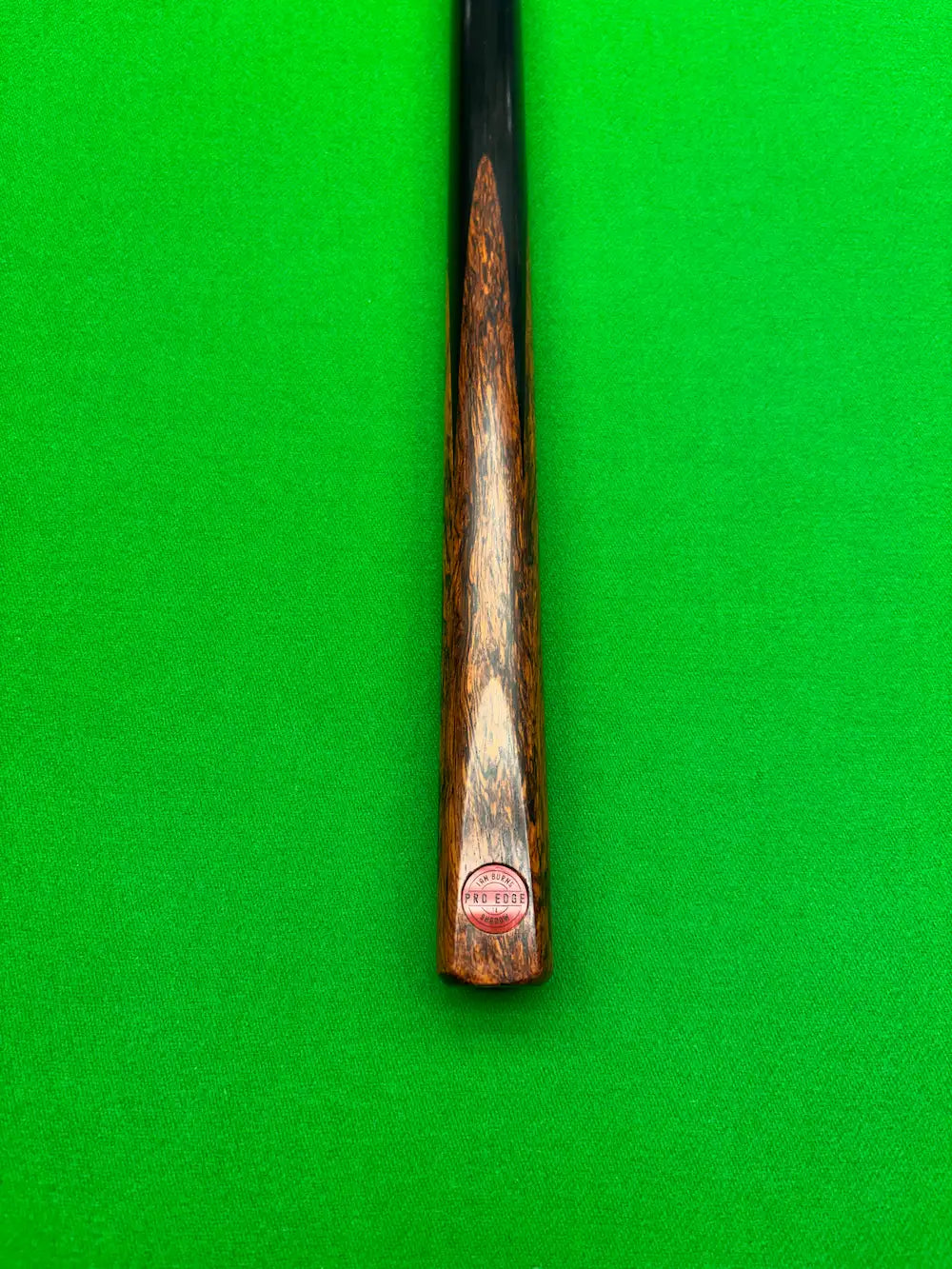 Ebony and Lava Rosewood butt snooker cue on a snooker table by pro edge snooker