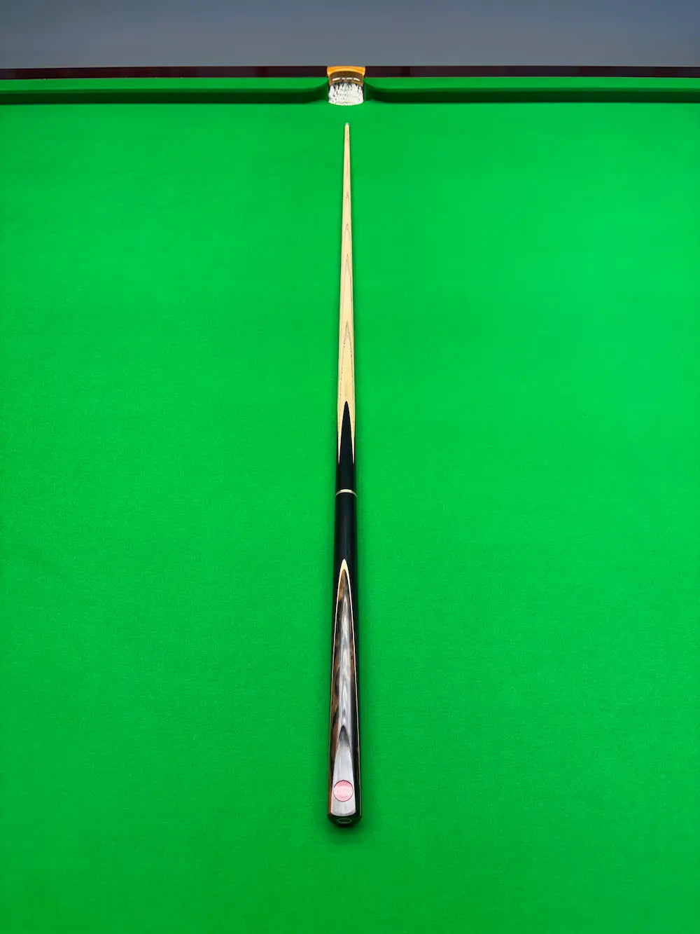 exotic wood snooker cue on a snooker table