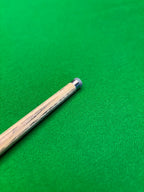 snooker cue with a titanium ferrule on a snooker table