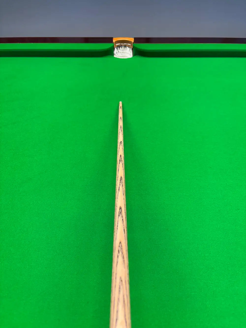 top view of a snooker cue with a brass ferrule and a pro edge tip