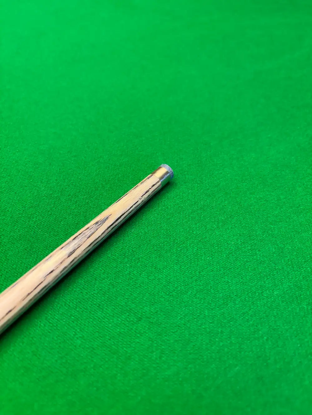 snooker cue with a brass ferrule on a snooker table by proedge