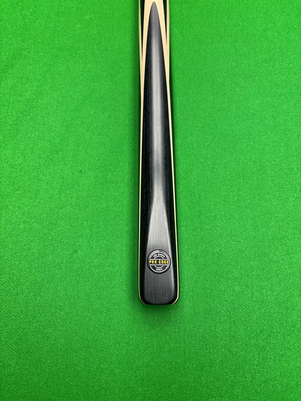Pro Edge Precision ash snooker cue 1 Piece resting on a green snooker table