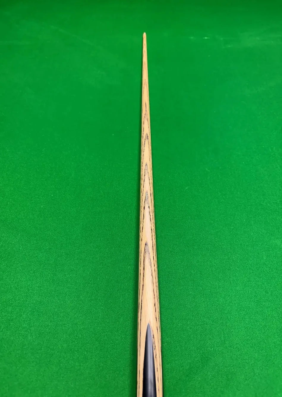 Pro Edge Precision 1 piece ash snooker cue resting on a green snooker table