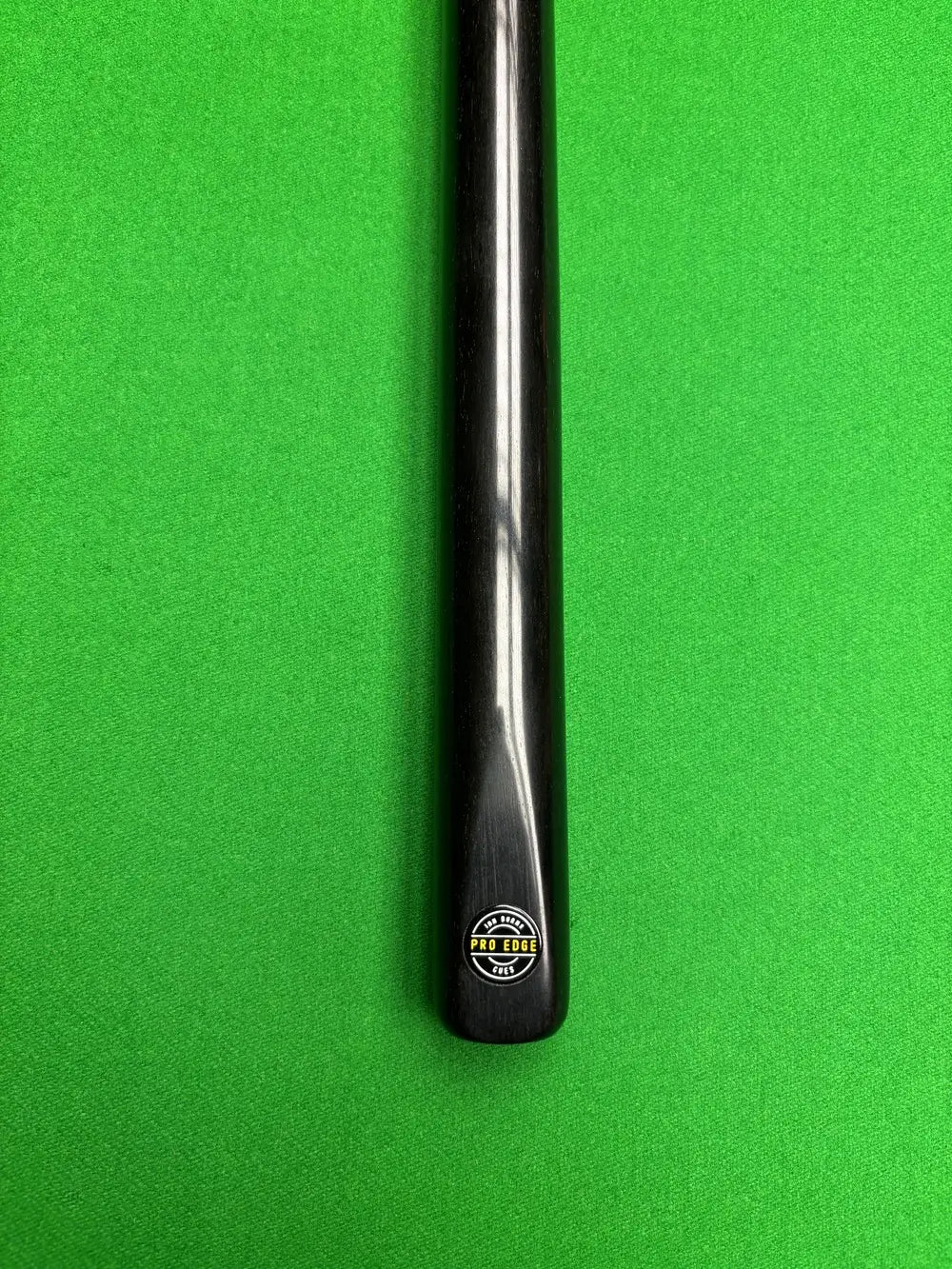 black ebony pro edge precision snooker cue on green snooker table