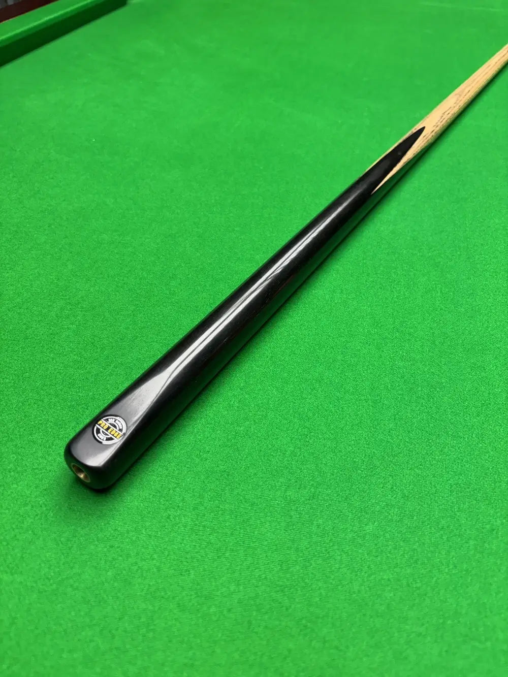 Snooker cue on a green snooker table 