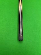 Pro Edge Precision Cue resting on a green snooker table, showcasing sleek design and professional craftsmanship.