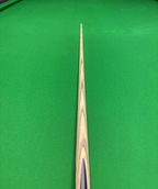 Pro Edge Precision Cue resting on a green snooker table, showcasing sleek ash design and professional craftsmanship.
