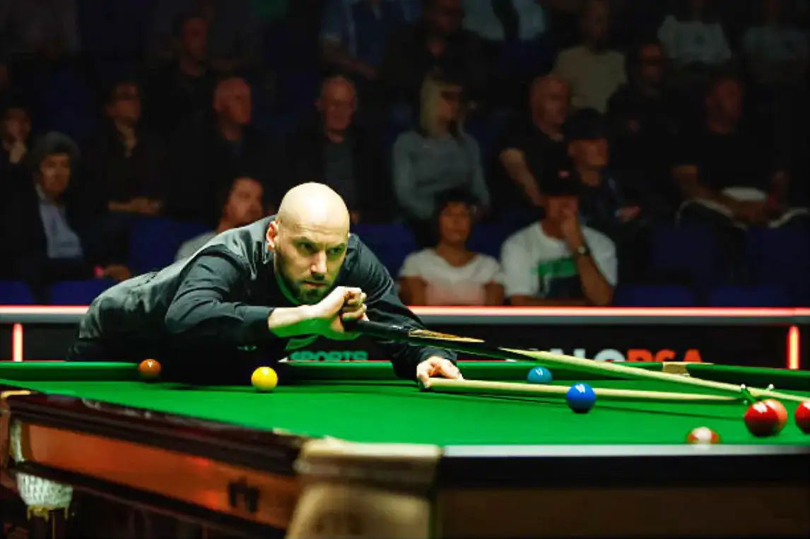 Ian Burns playing snooker in a dimly lit room with spectators in the background