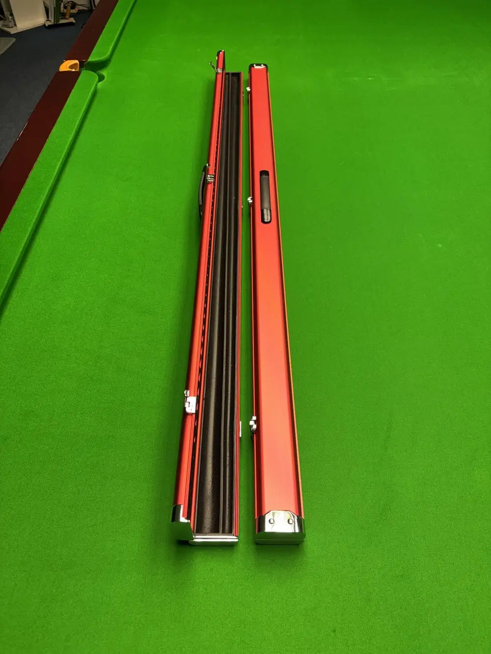 Red slimline aluminium cue case with a modern streamlined profile, designed for secure snooker cue storage and easy transport