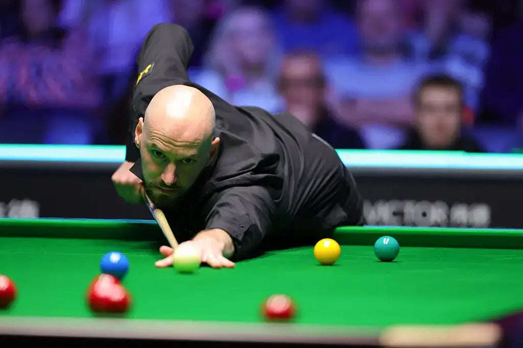 Snooker player Ian Burns in action on a green snooker table