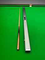 snooker cue and case on a snooker table