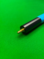 Close-up of a snooker cue extension with a black and blue grip, featuring a brass ball end, resting on a green felt table surface.
